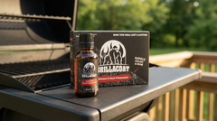 Grillacoat protective grill coating bottle and kit displayed on a BBQ grill grate