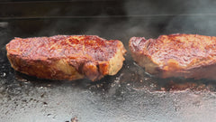 Steaks searing on a griddle protected with Grillacoat ceramic coating - easy cleanup grilling